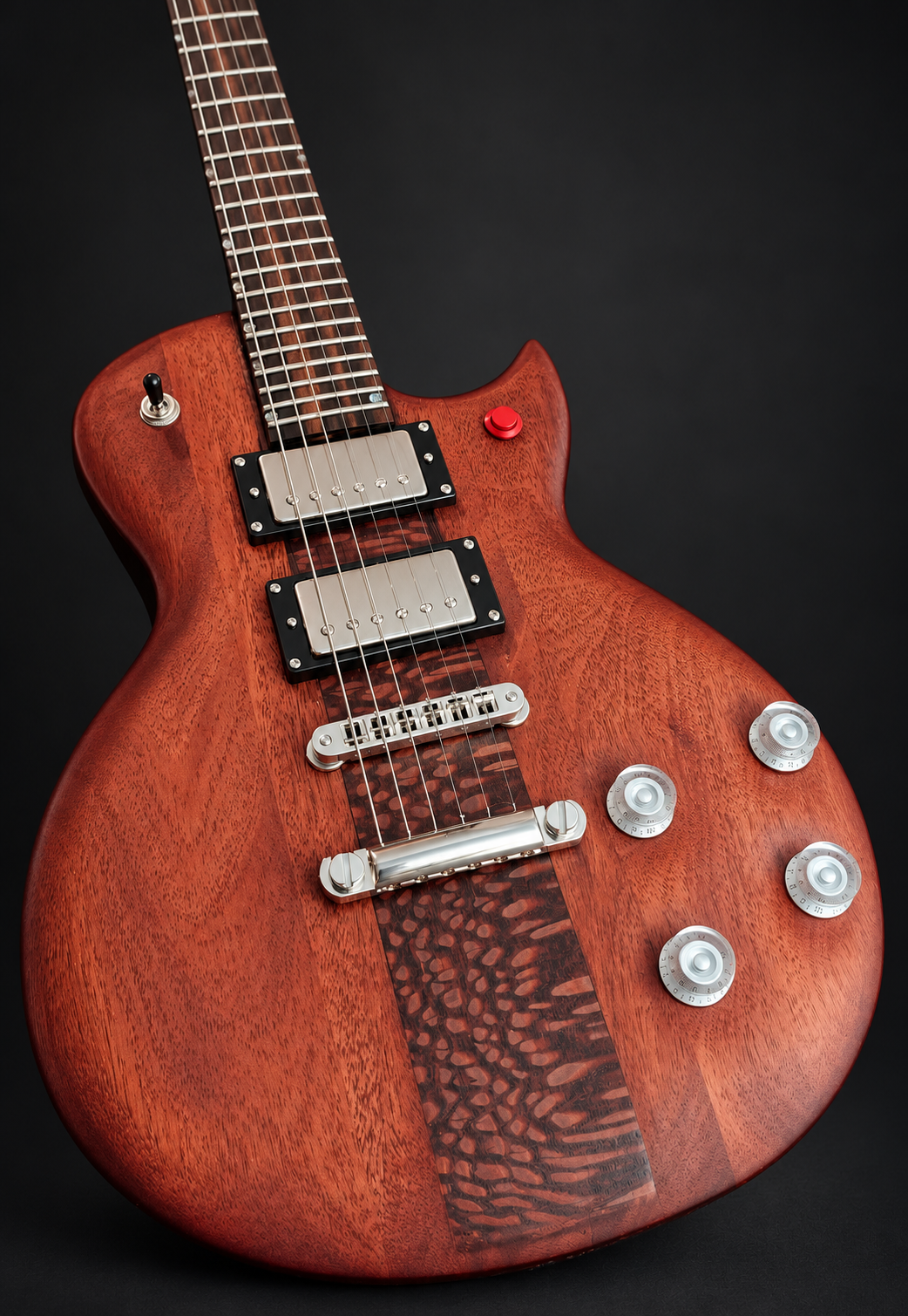 Detail of the red guitar’s grain, chrome pickups, and figured center stripe
